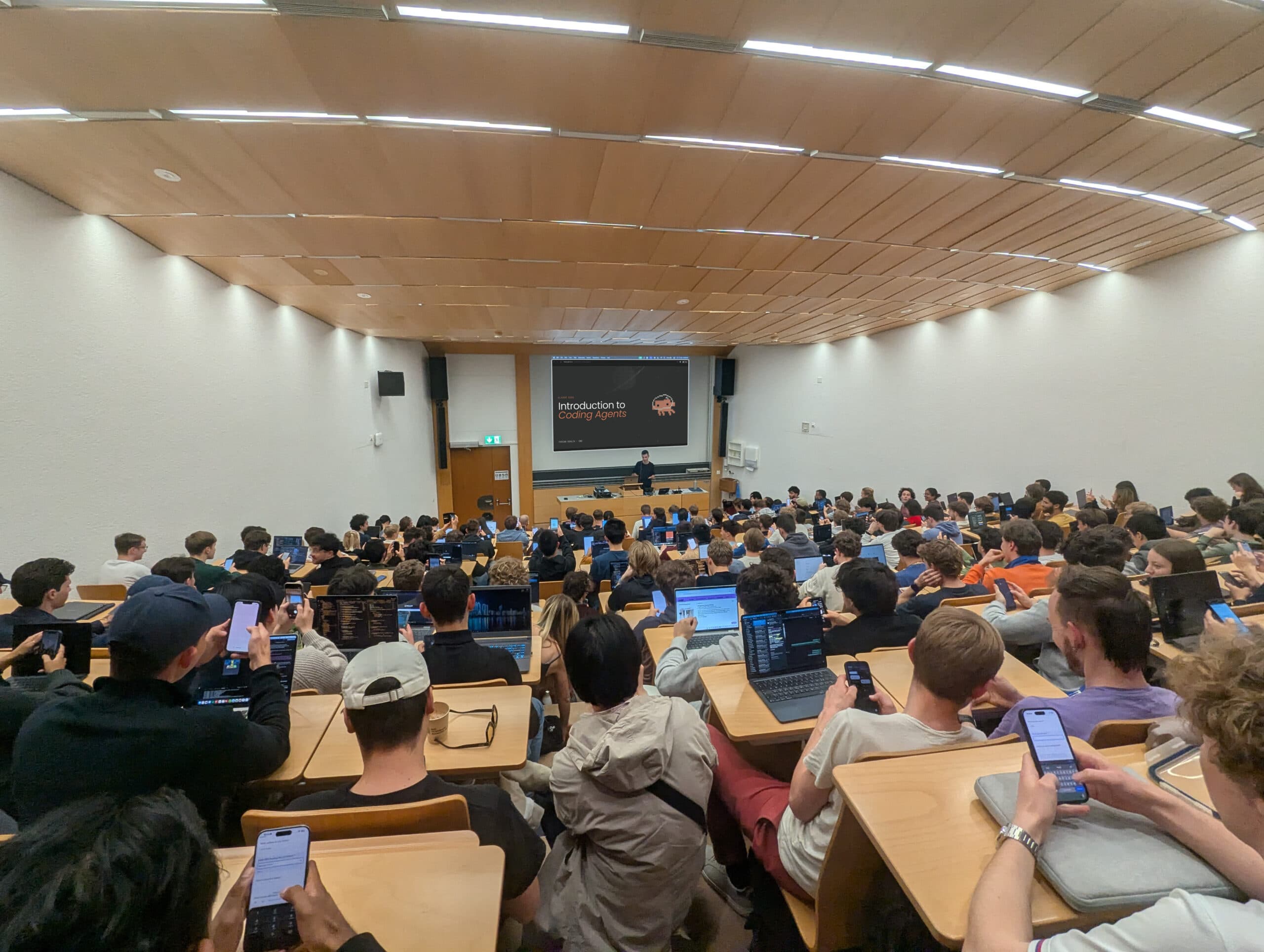 Lecture hall filled with attendees during the Introduction to Coding Agents talk